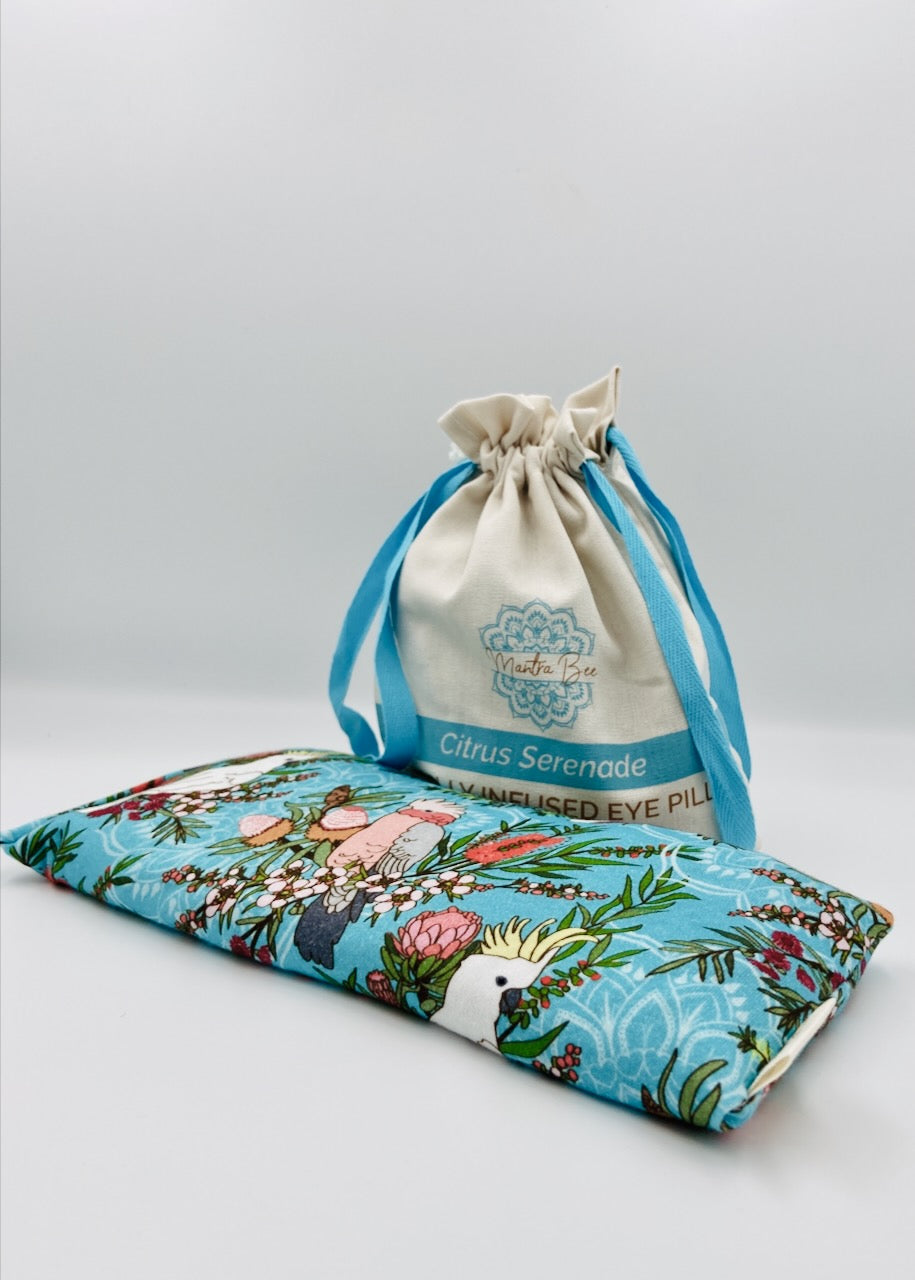 Floral Australiana eye pillow with a drawstring bag on a light gray background