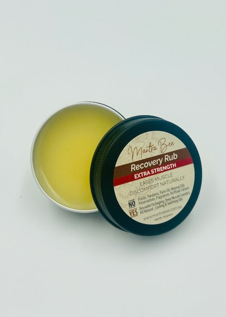Tin of recovery rub with a label on a white background